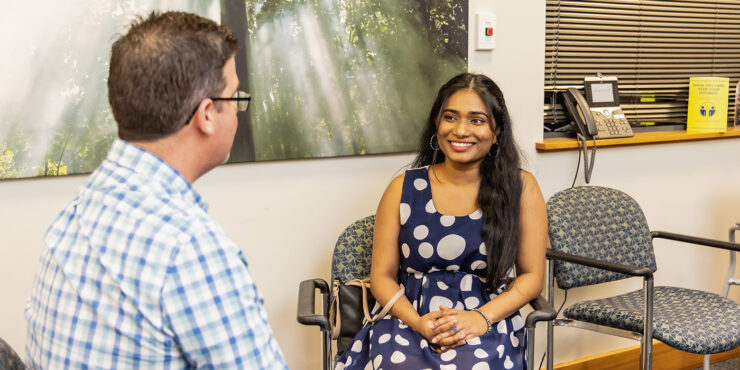 A student smiling at a counsellor