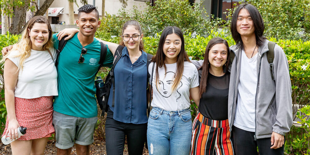 Six students standing next to each other