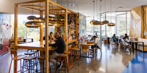 People eating and studying in a common area