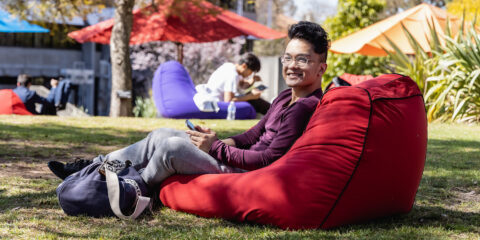 Student sitting in beanbag on their phone