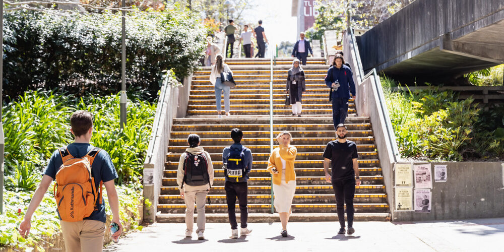 People walking up and down a large outdoor staircase