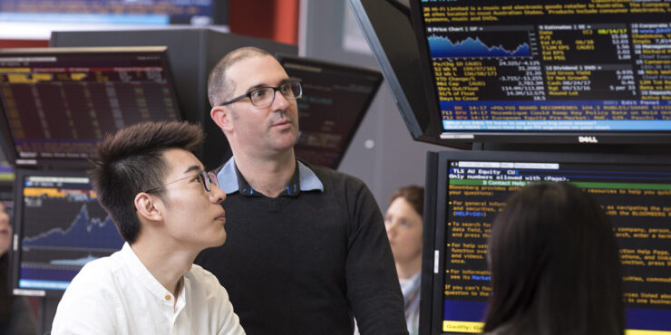 Two people looking at digital screens