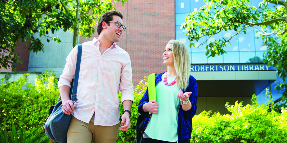 2 students talking to each other while walking