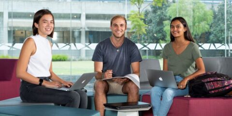 Three people on laptops sitting together in a room