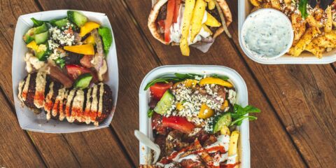 Selection of Greek food in takeout containers