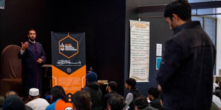 A group of men listening to a talk by Imam Yahya