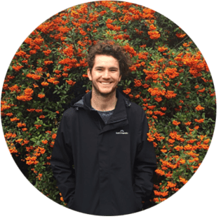 Person standing in front of a flowering bush