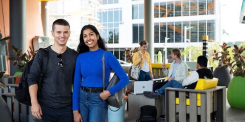 2 students smiling at the camera