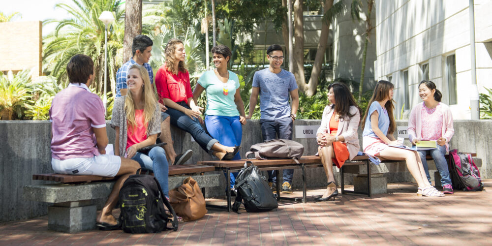 group of people sitting at a bench