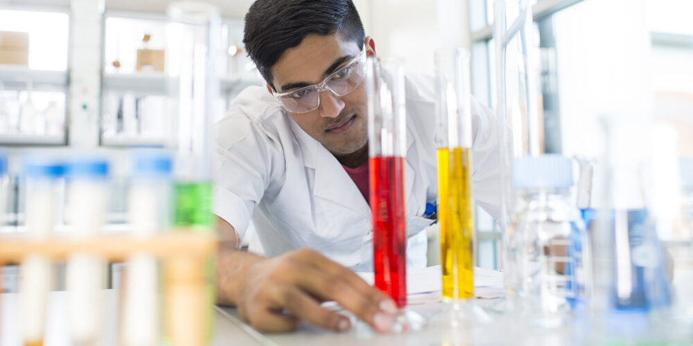 student conducting tests in test tubes