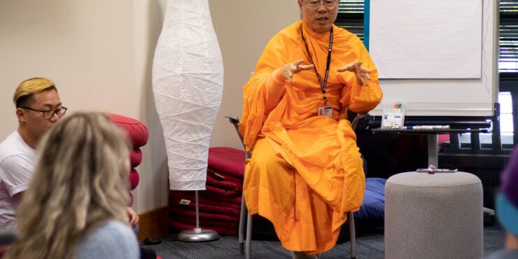 People listening to a Buddhist monk preach